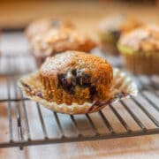 Zucchini Blueberry Muffins on a paper muffin cup