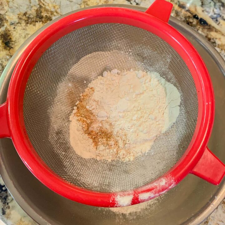 sifting dry ingredients into a bowl