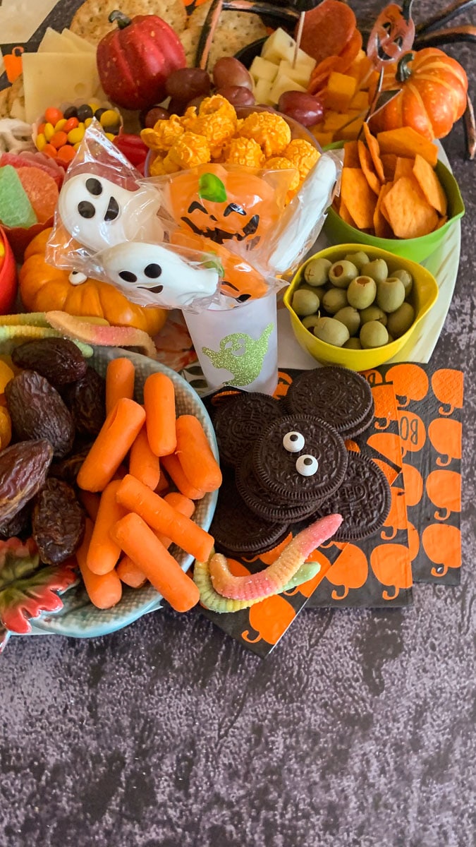carrots, Oreos with eyes, olives, on a halloween charcuterie board