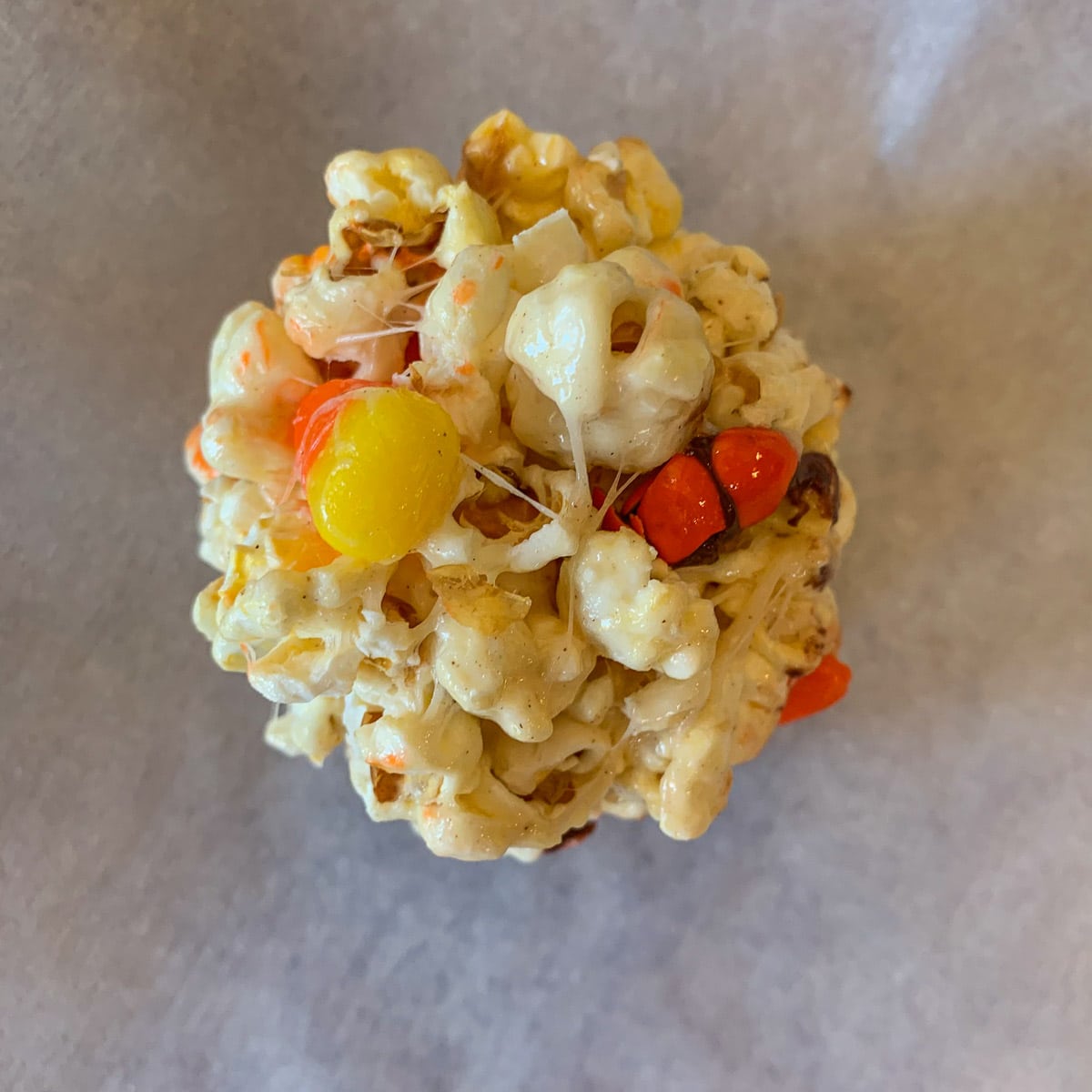 halloween popcorn ball on parchment paper