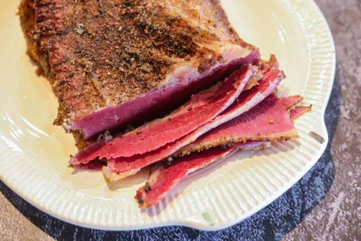 sliced smoked pastrami on white plate