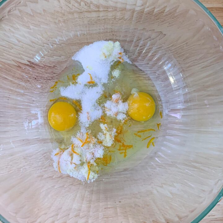 eggs, sugar, and orange zest in a bowl