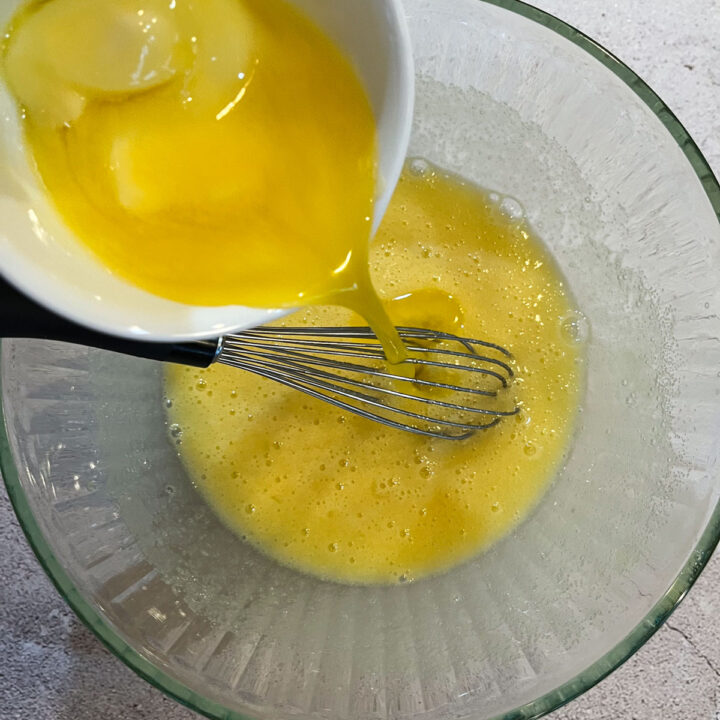 butter being whisked in a glass bowl