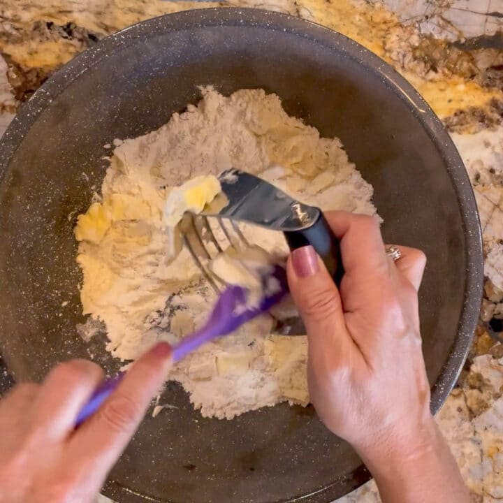 scraping dough off of pastry cutter