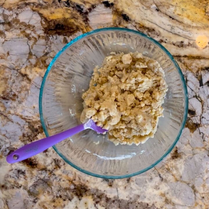 glass bowl with Nazook filling ingredients and a purple spatula