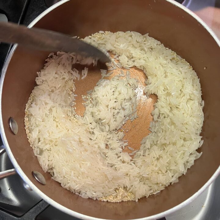 rice being stirred in a pot