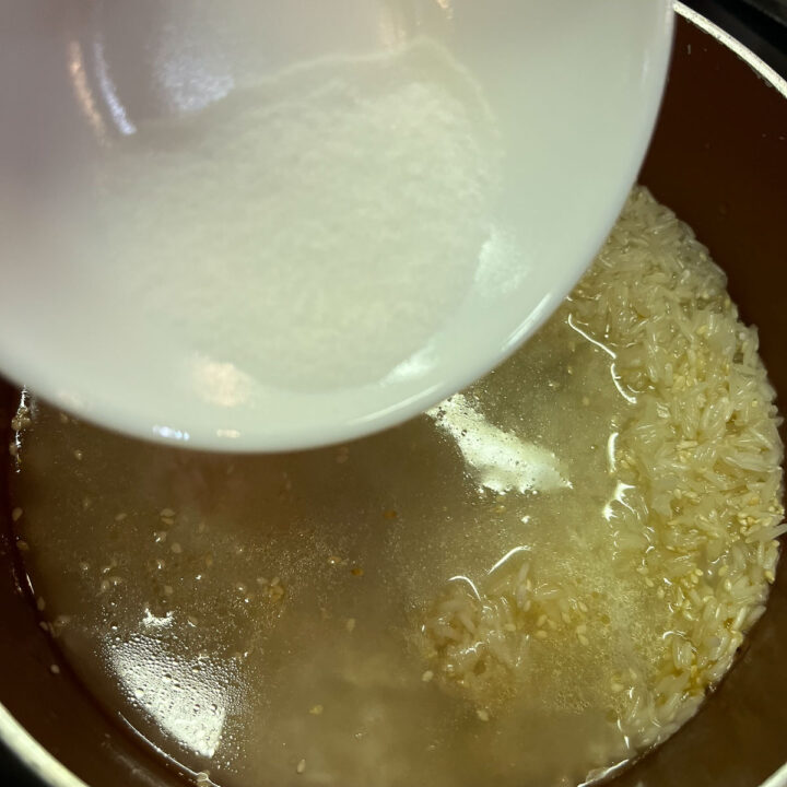 water being added to a pot of rice