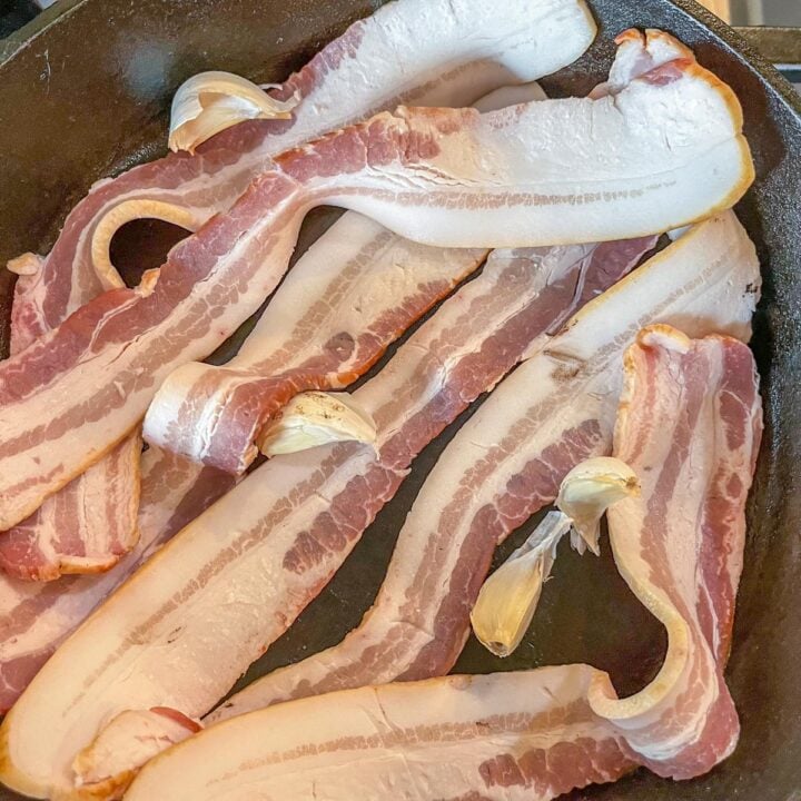 raw bacon and garlic in a pan