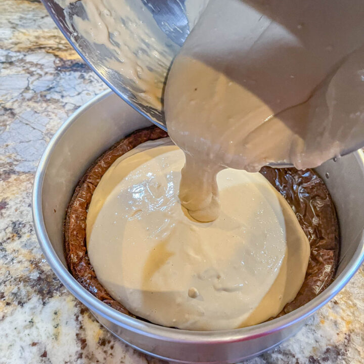 pouring coffee cheesecake batter into a pan