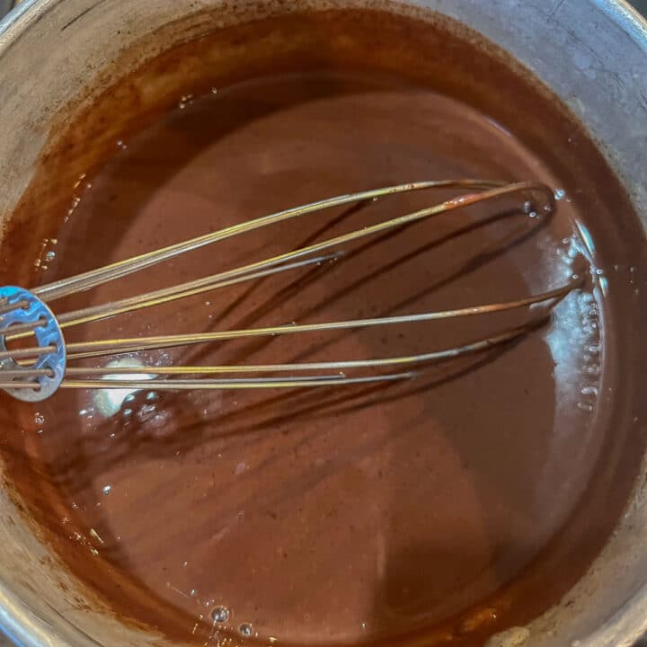 whisking chocolate sauce in a pan