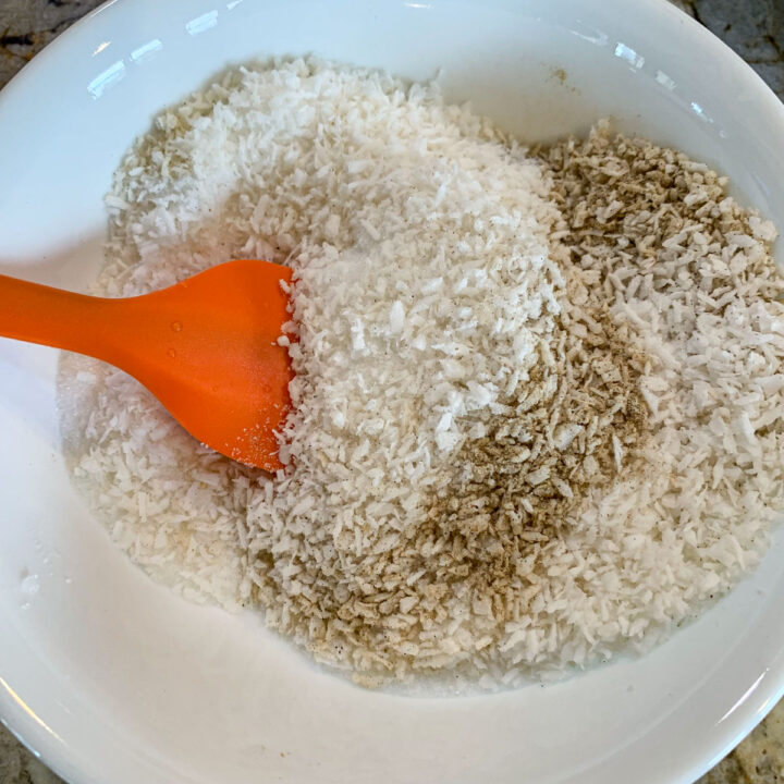 cardamom and coconut being stirred in a white bowl