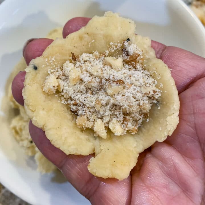 a piece of dough filled with walnut filling