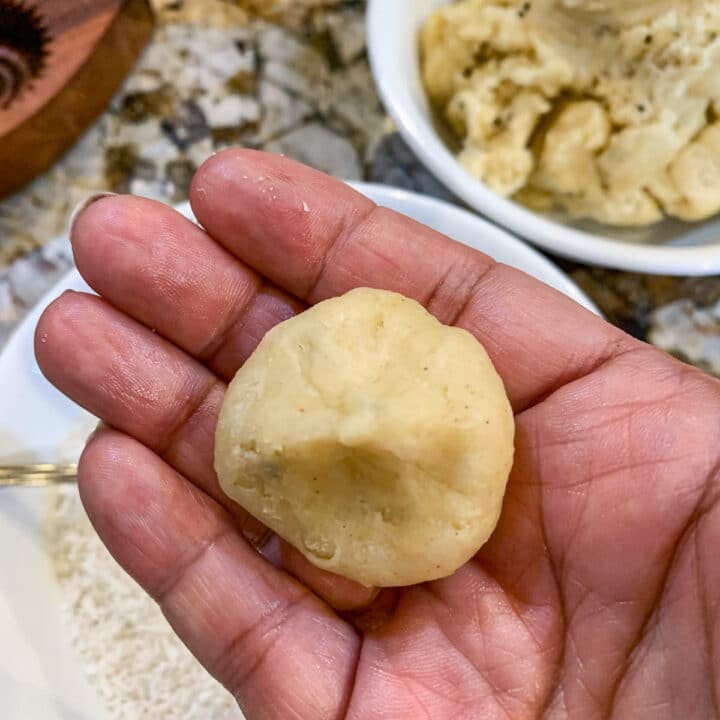 unbaked dough ball in a hand