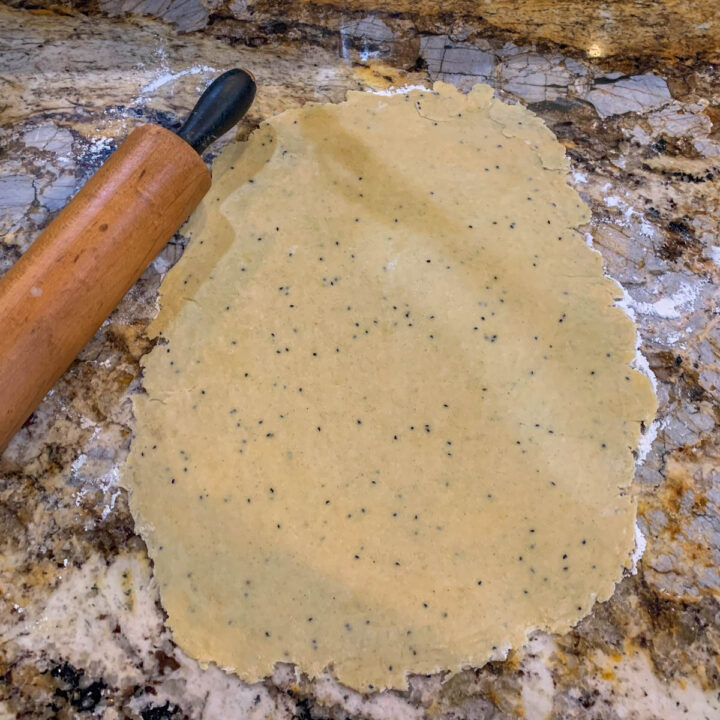 dough rolled out and a rolling pin next to it
