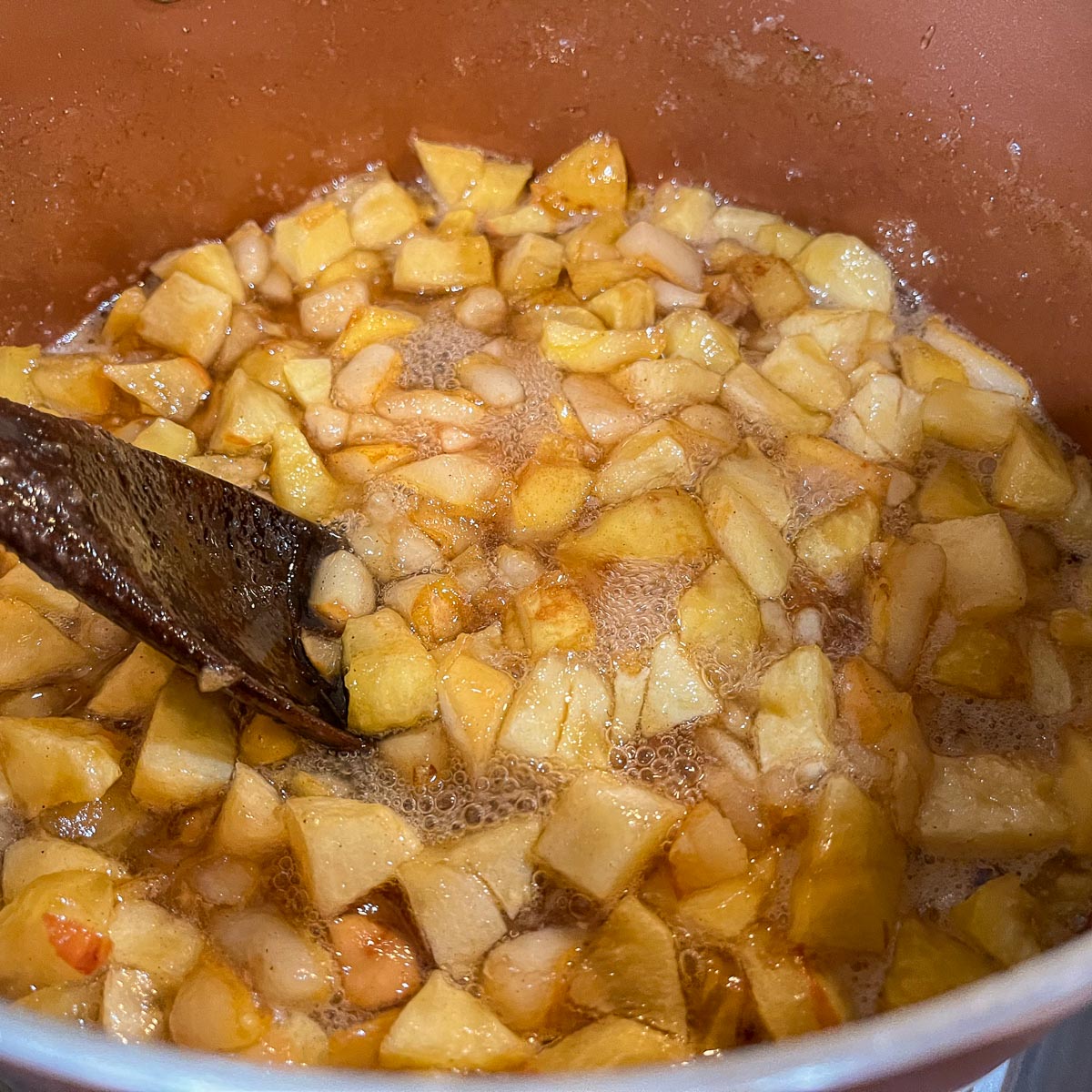 stirring a pot of pear apple preserves