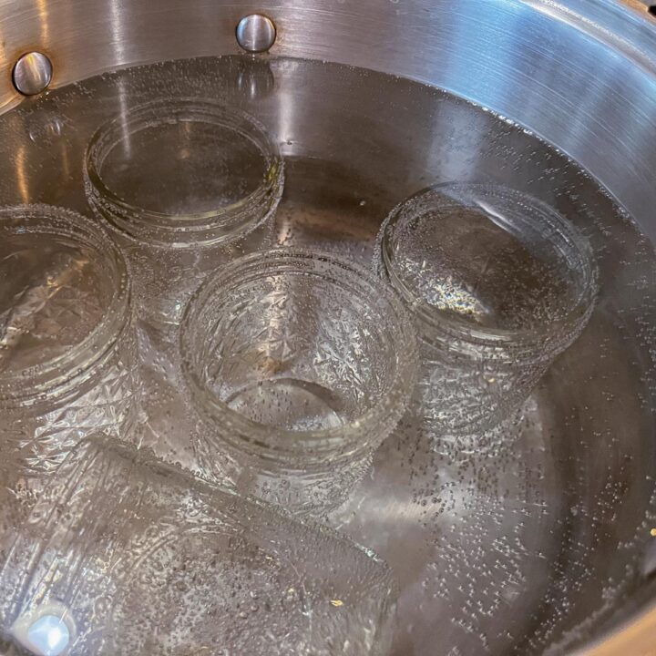 empty jars being sterilized in a pot