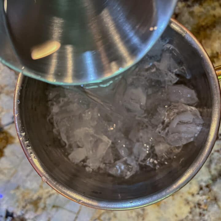 pouring vodka ove ice