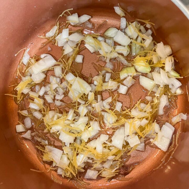 chopped onions and vermicelli frying in a pot