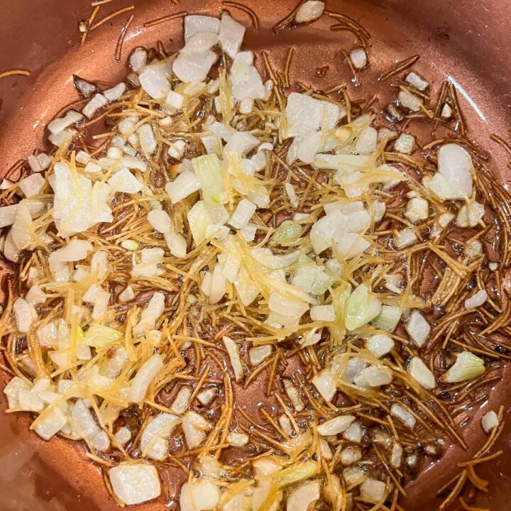 chopped onions and vermicelli frying in a pot 2