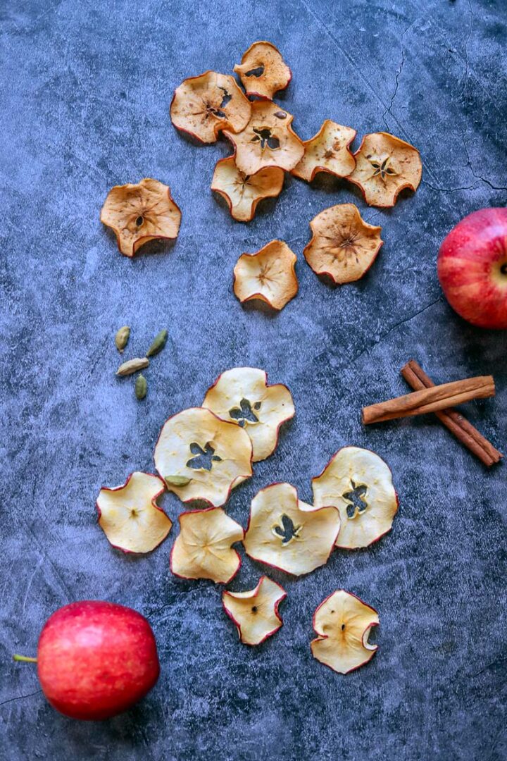 dehydrated apple chips, cinnamon sticks and apples