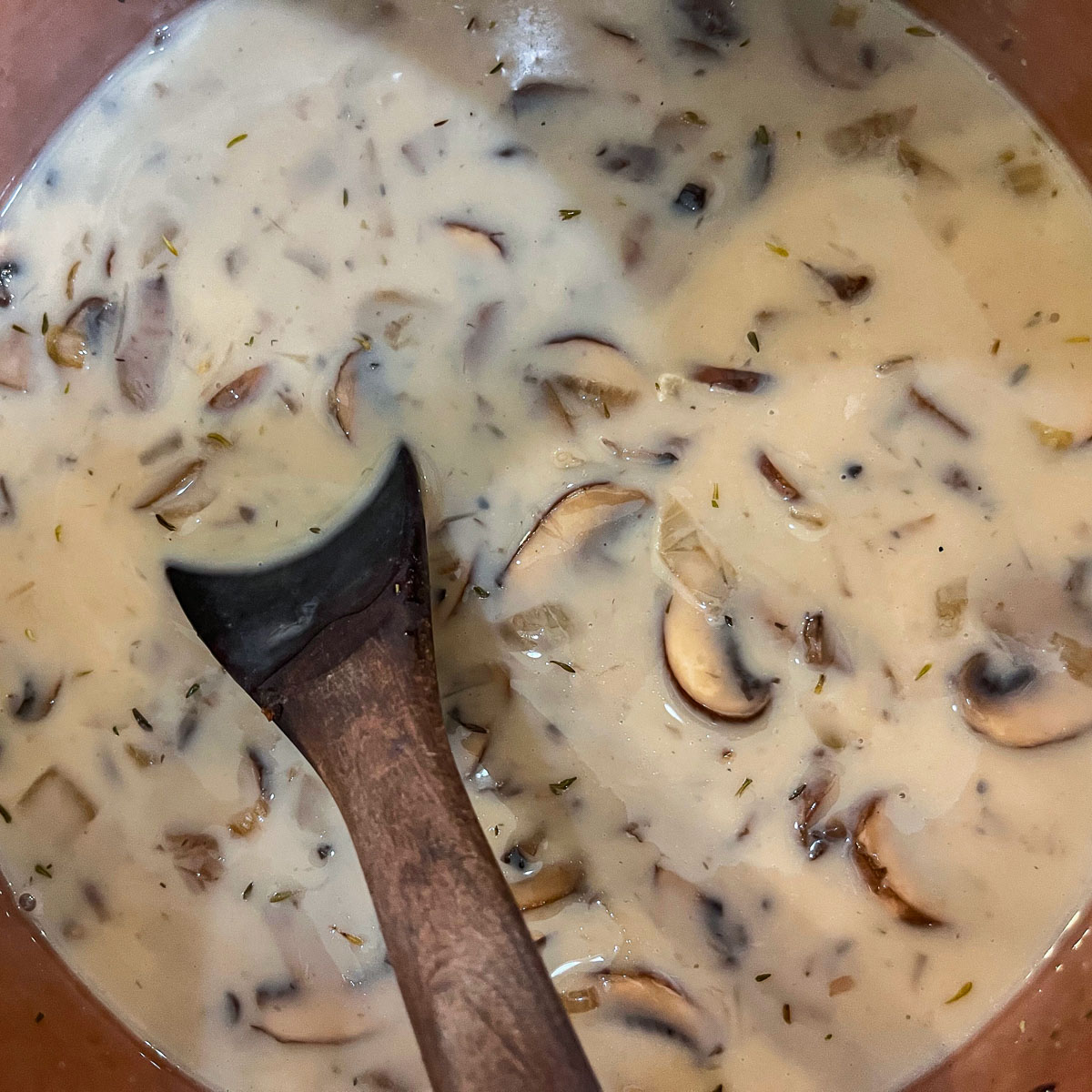 stirring vegan mushroom soup
