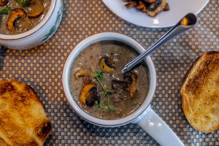 cream of mushroom soup with sourdough next to it