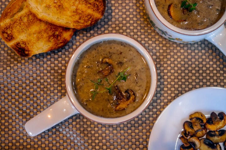 vegan cream of mushroom soup with toast, and additional mushrooms on the side