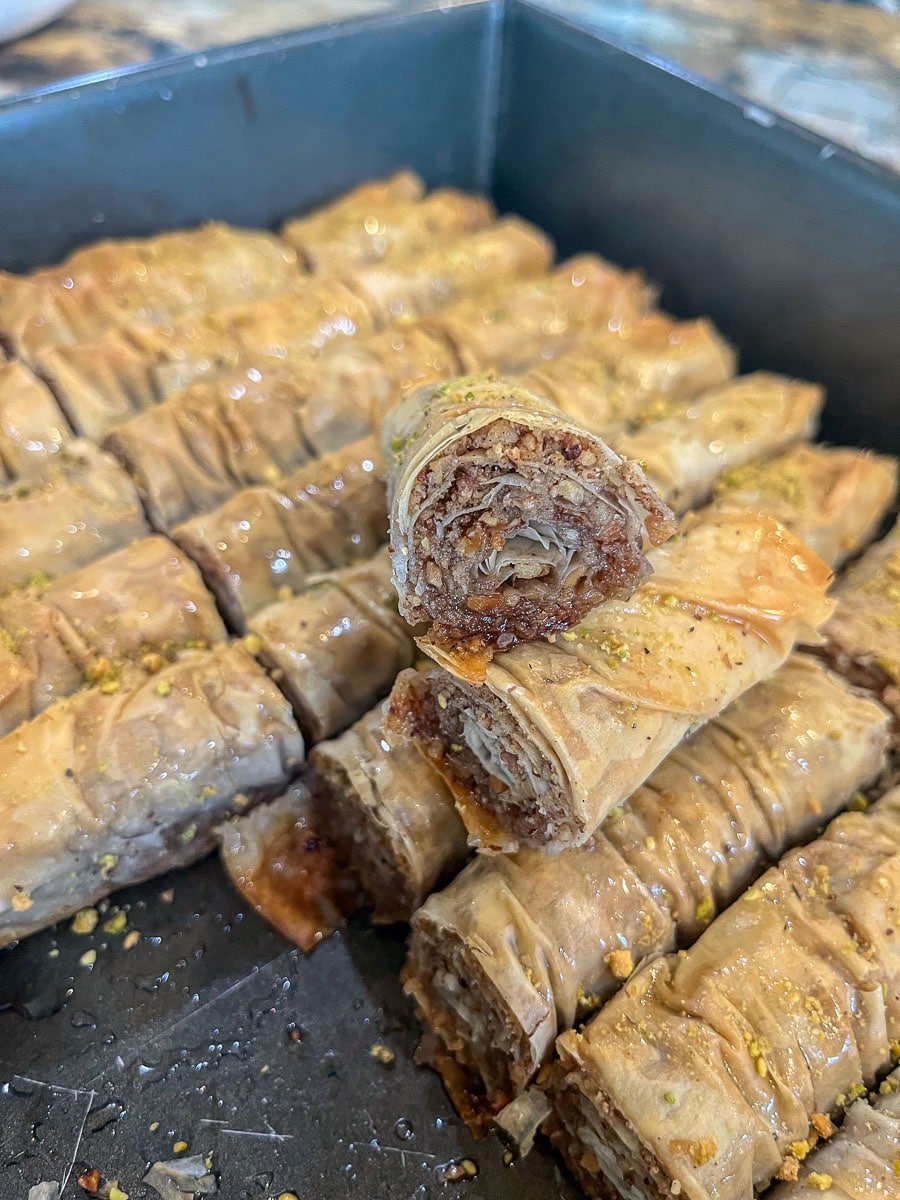 rolled Burma baklava stacked on eachother in a pan