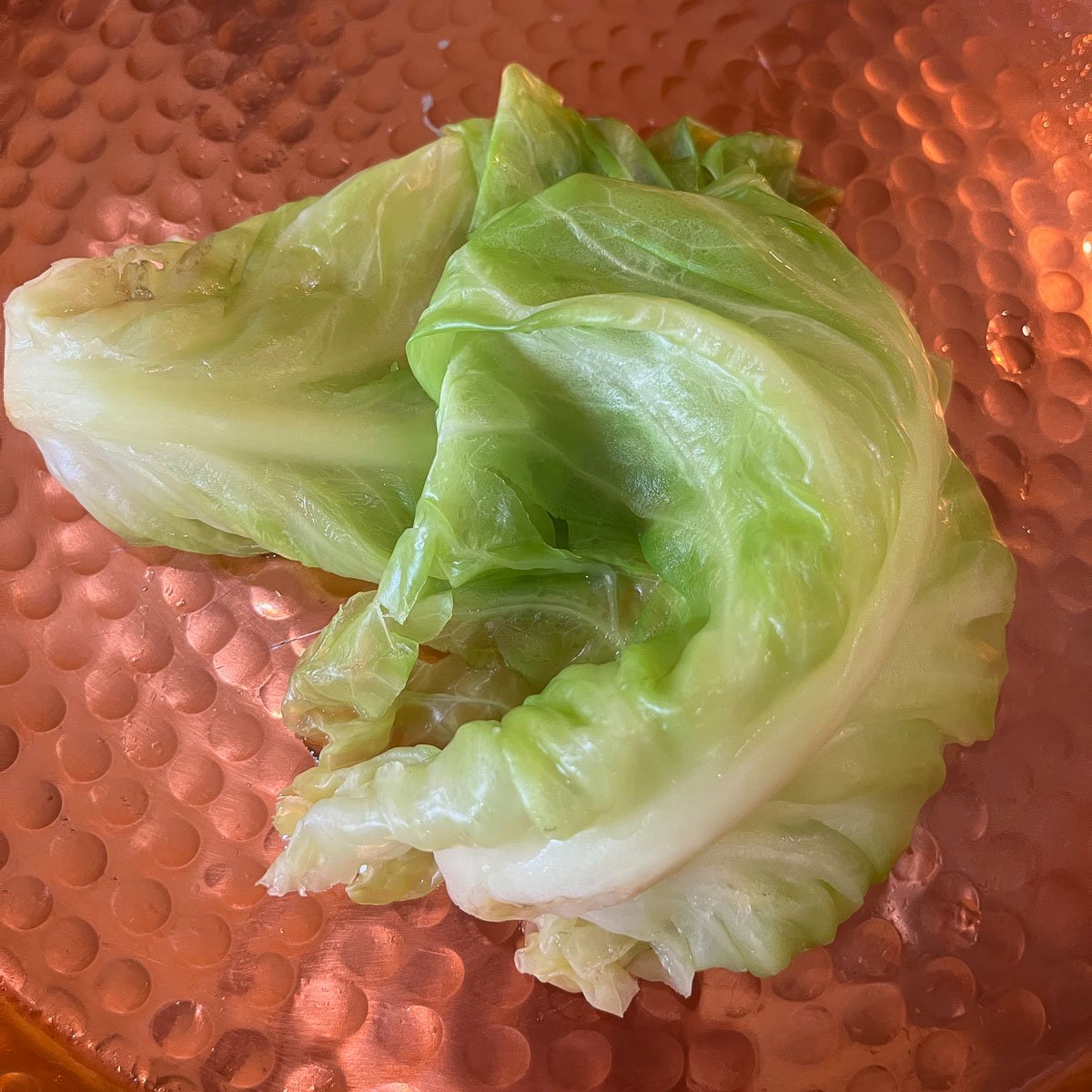 cooked cabbage leaves on a pan