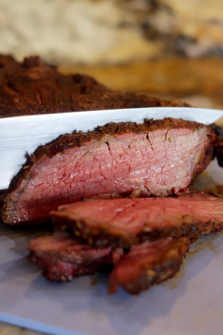 smoked tri-tip being sliced