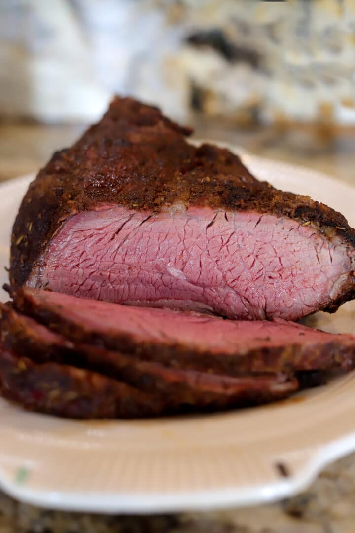 smoked tri-tip sliced on a white plate