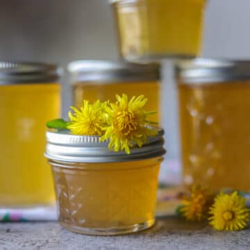 jars of dandelion jelly stacked on eachother