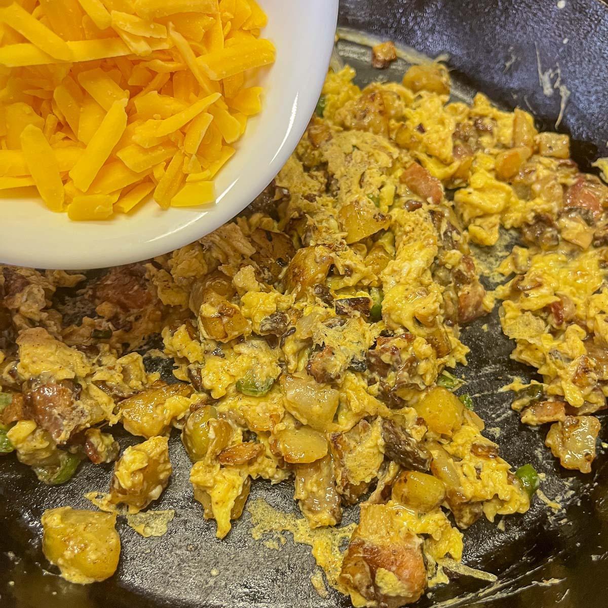 cheesy scrambled eggs in a pan