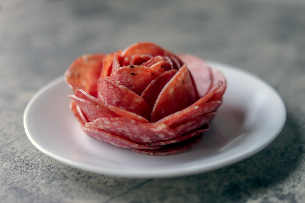 how to make a salami rose on a white plate
