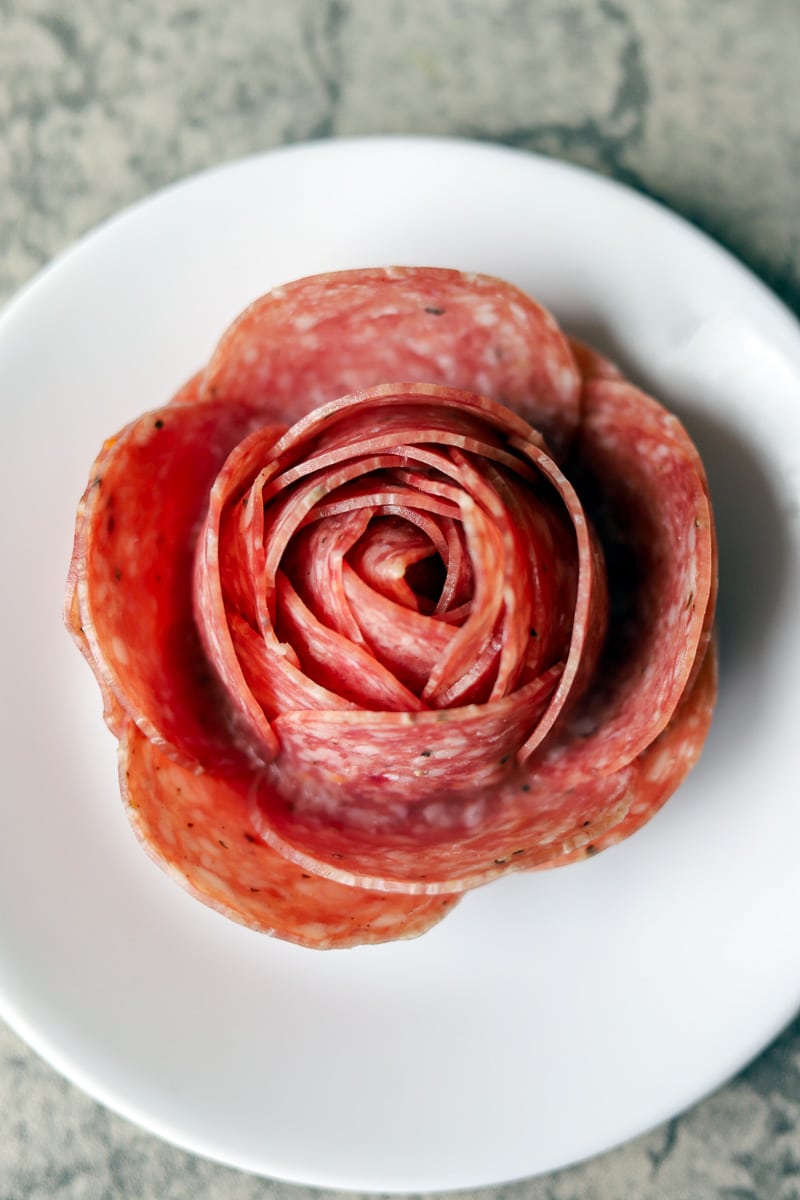 how to make a salami rose on a white plate