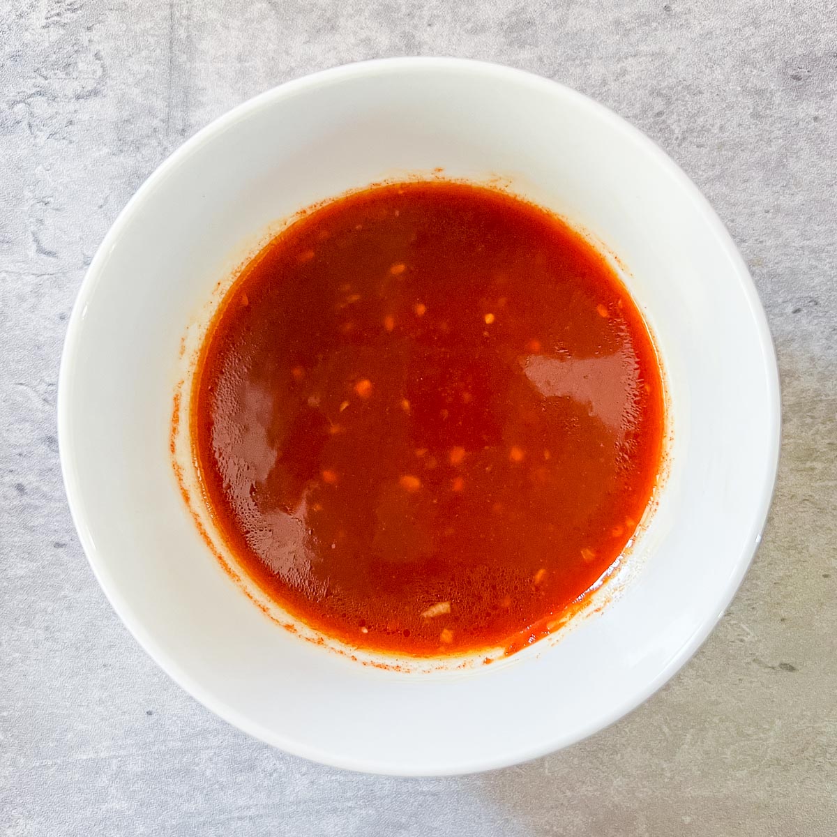 Spicy Korean sauce for the noodles in a white bowl