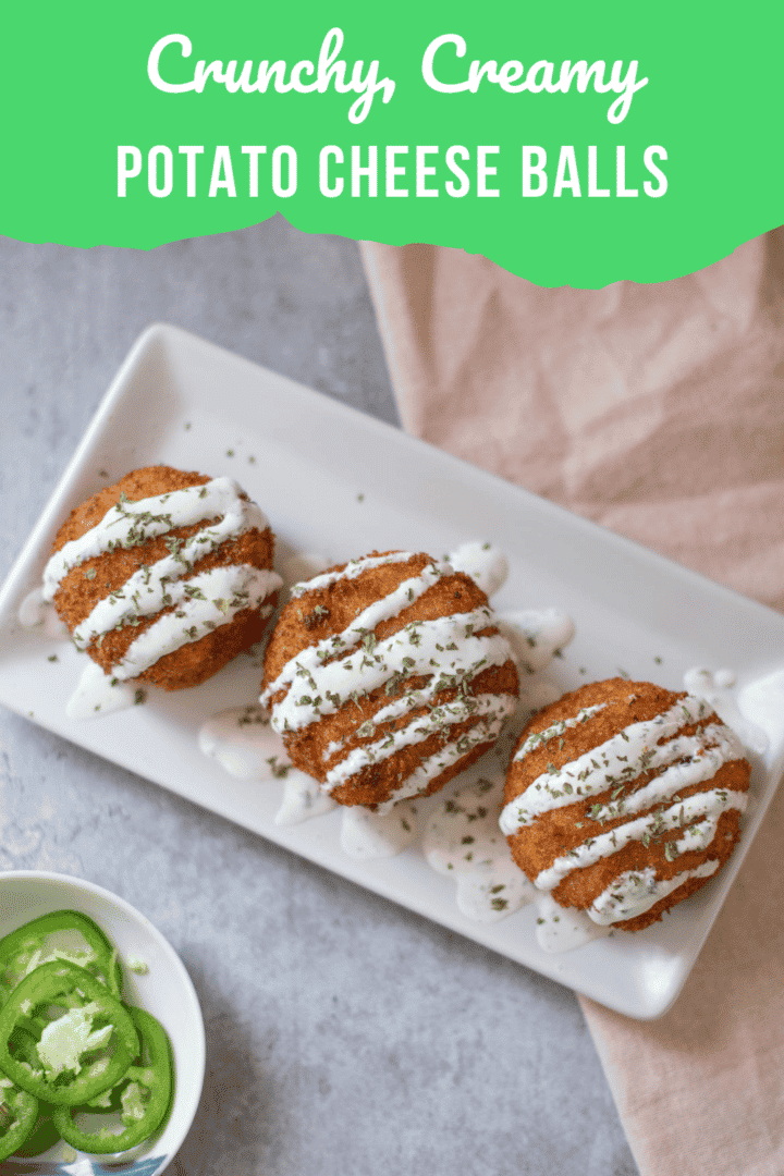 potato cheese balls drizzled with ranch on top and jalapeños on the side