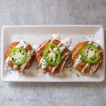potato cheese balls with jalapeno and ranch on top