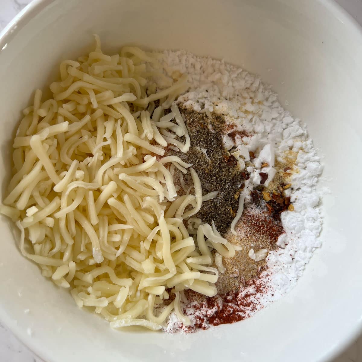 cheese and powdered ingredients unmixed in a bowl