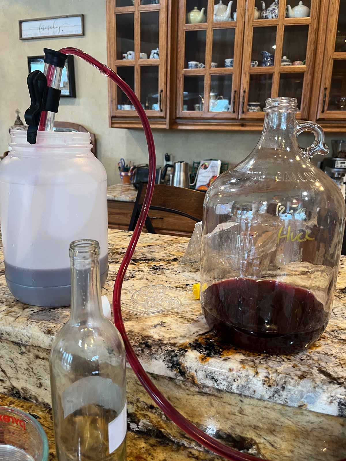 transferring blueberry wine into bottles