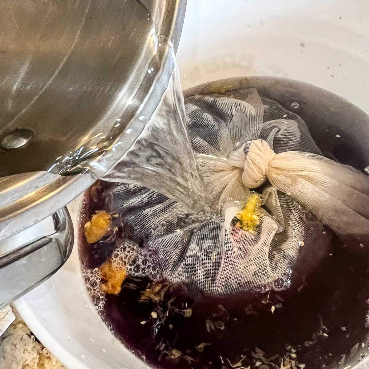 pouring water over fermentor bucket for wine
