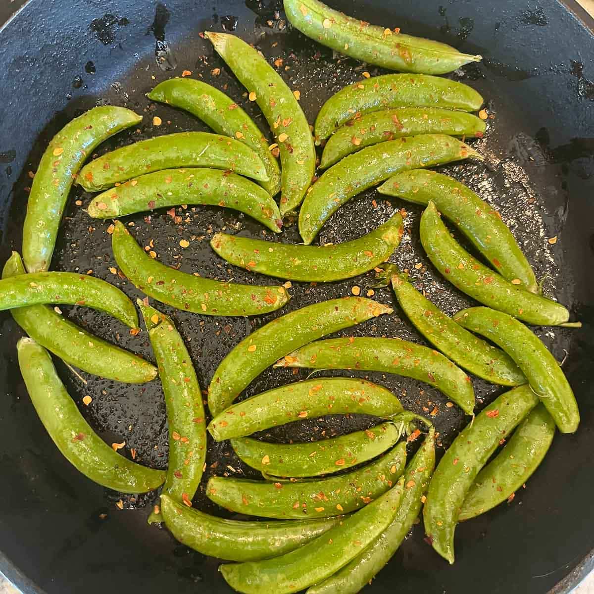 seasoned snap peas in a pan