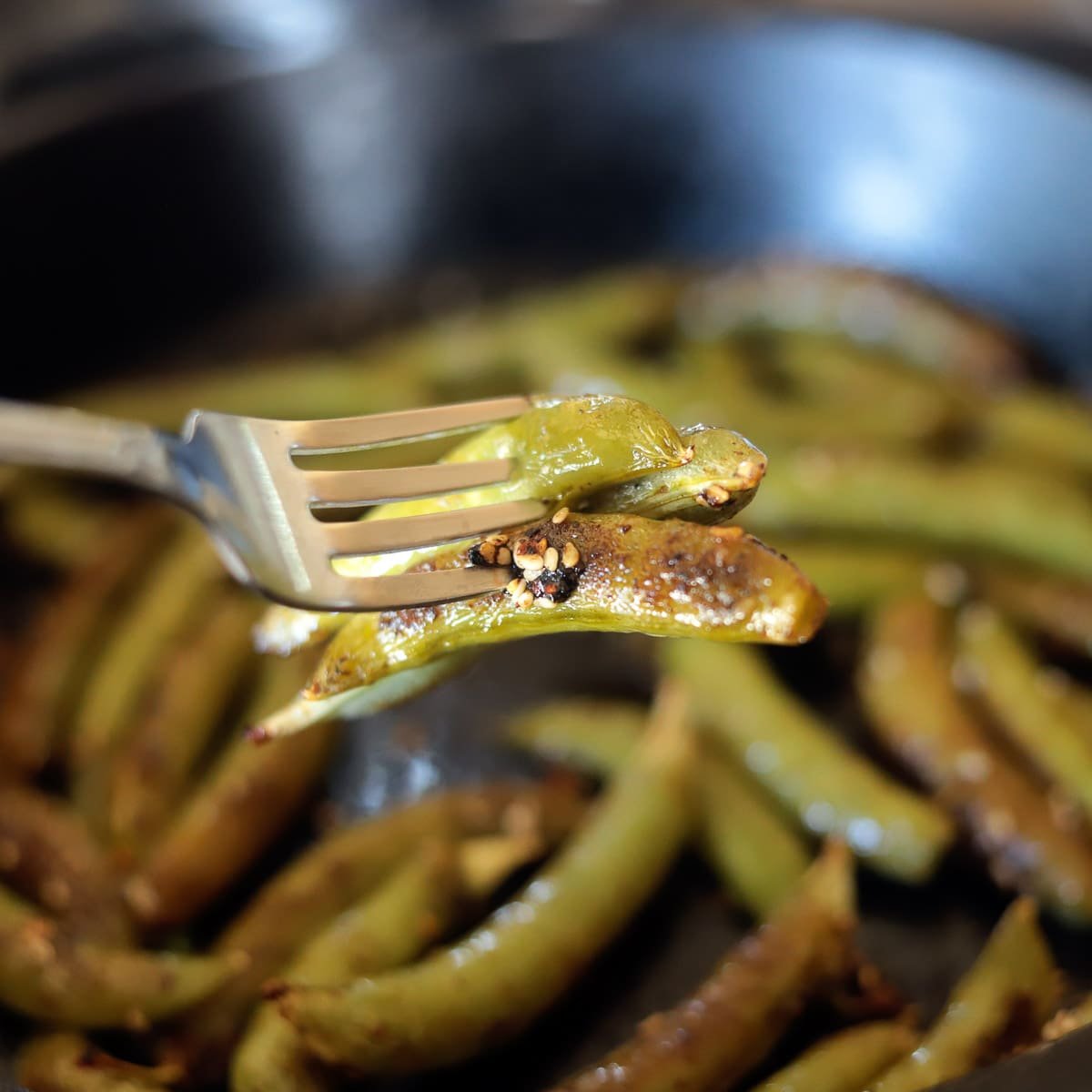 snap peas in a pan and on a fork