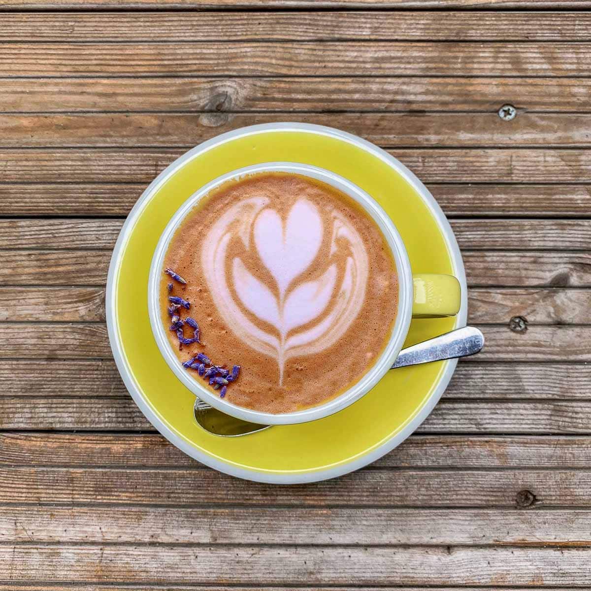 hot lavender latte in a yellow mug
