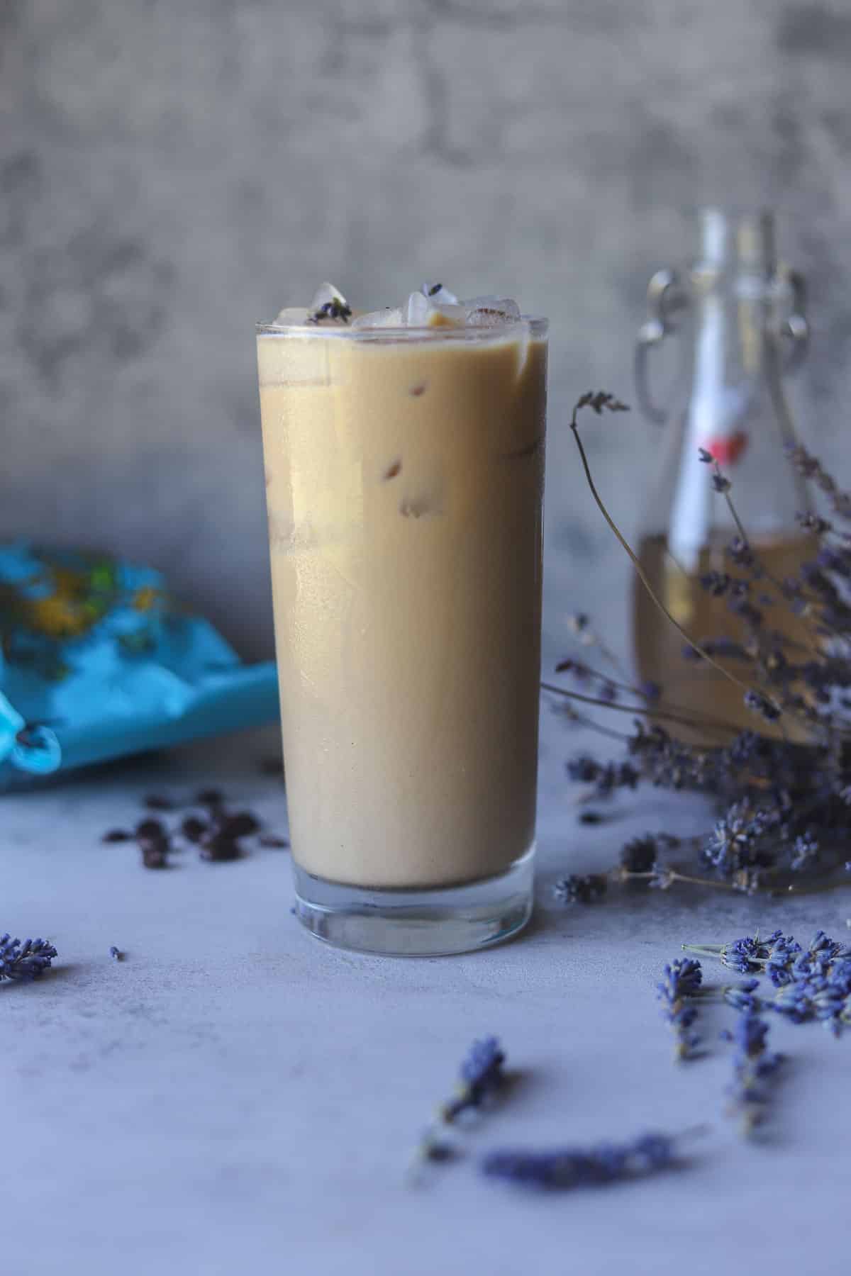 iced lavender latte with syrup in the background