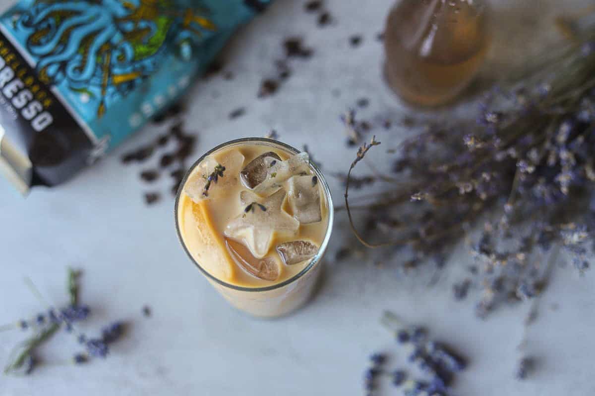 lavender latte with lavender around it.