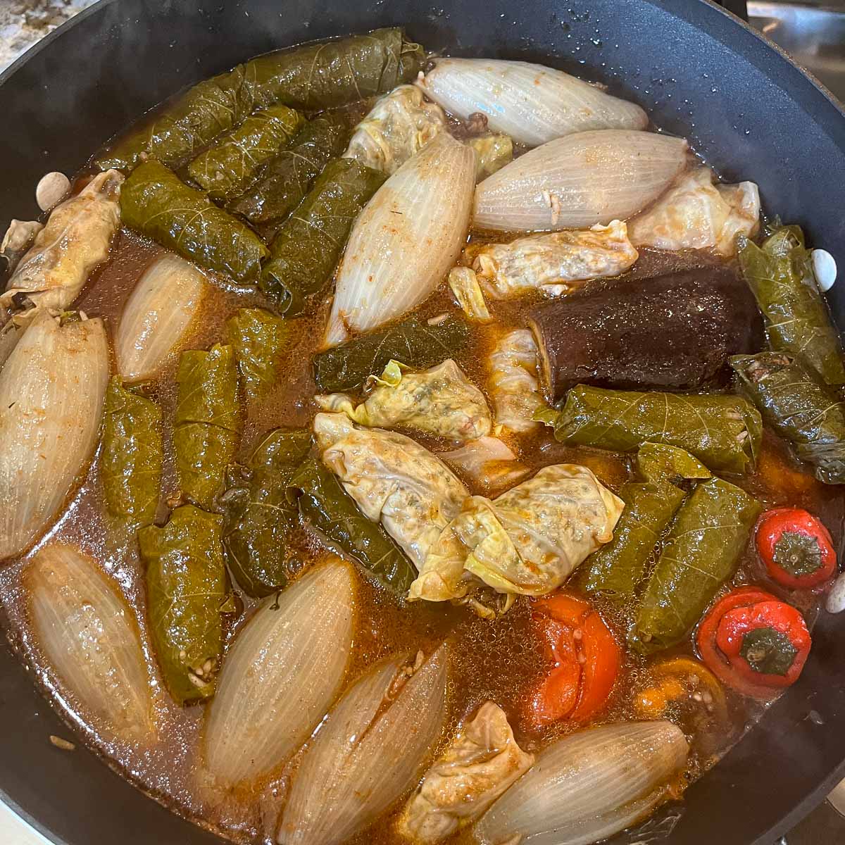 uncooked Iraqi Dolma with sauce over it