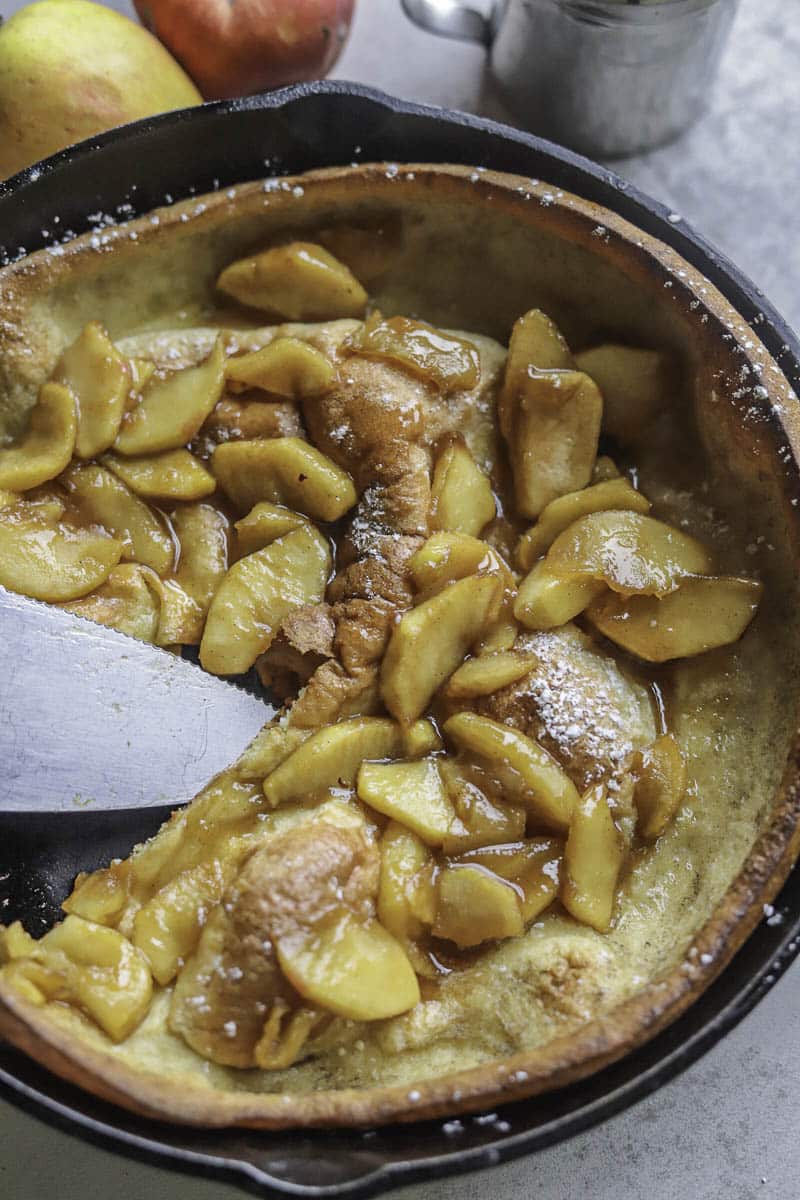 apple dutch baby with a slice missing