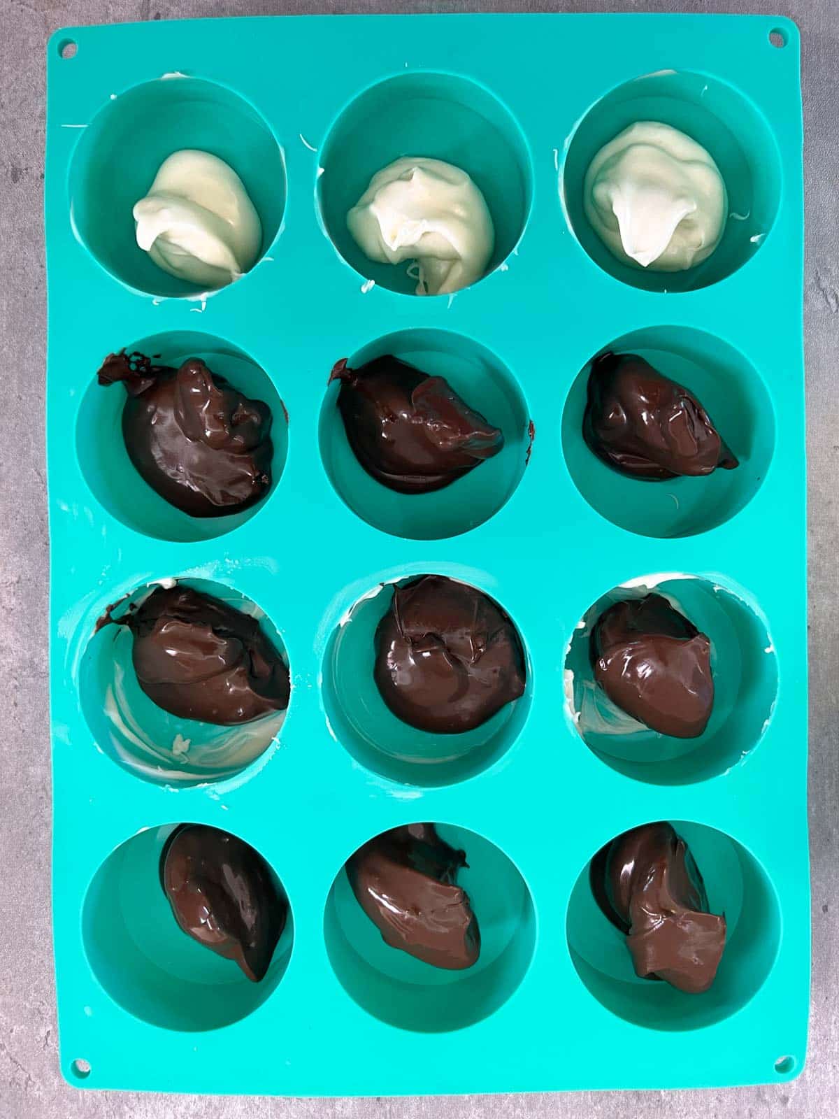 dollops of melted chocolate in mold