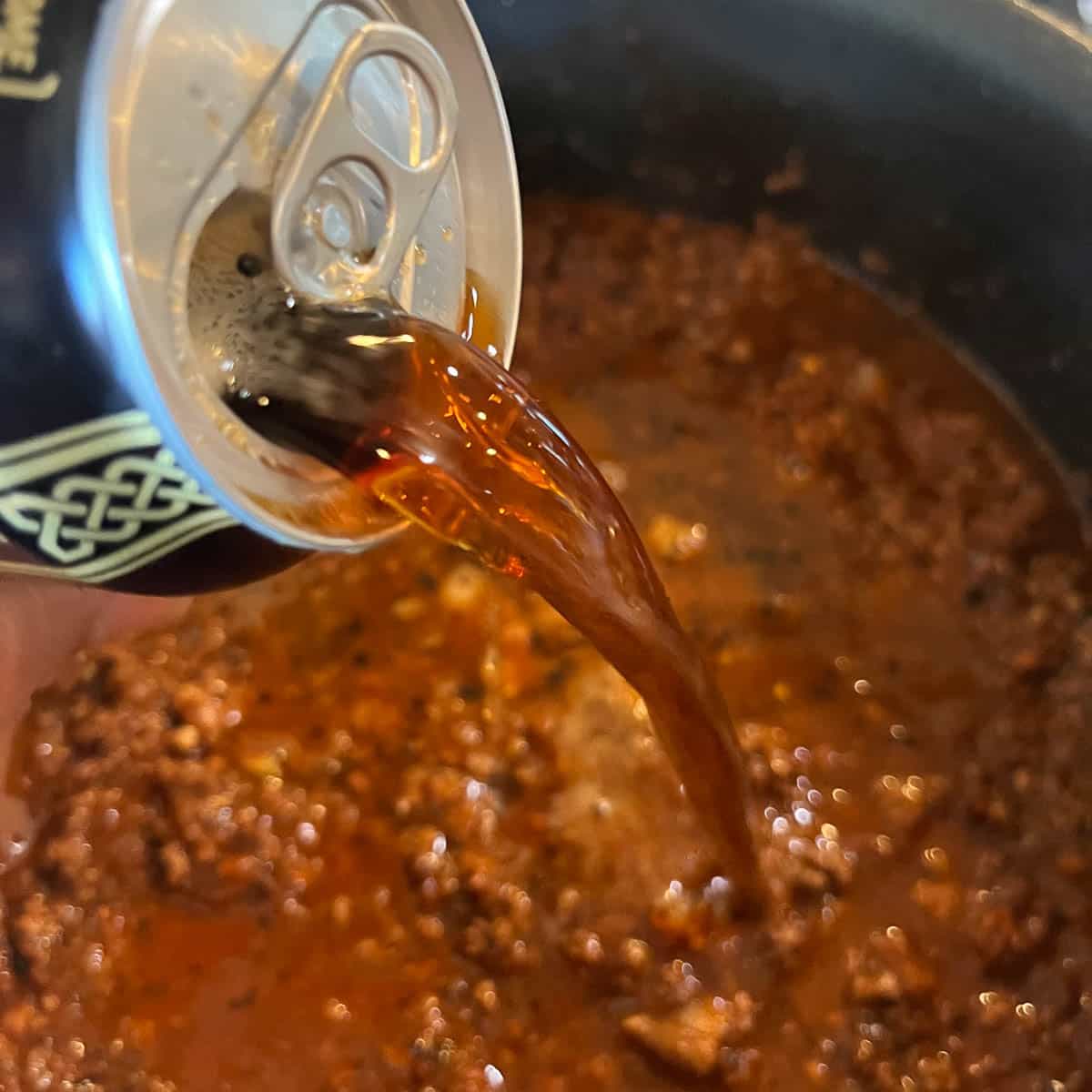 pouring beer into elk chili